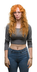 Young redhead woman depressed and worry for distress, crying angry and afraid. Sad expression. - obrazy, fototapety, plakaty