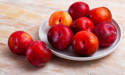 Sweet organic red plums on kitchen table