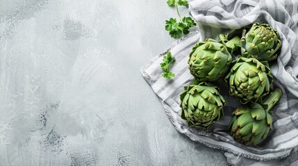 Close-up of artichokes and parsley on a cloth