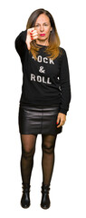 Beautiful middle age woman wearing rock and roll sweater looking unhappy and angry showing...
