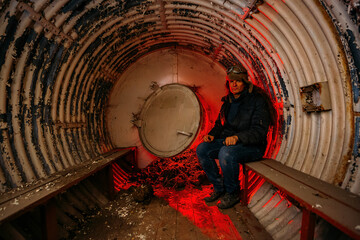 Man in temp quick-build bomb shelter