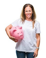Middle age hispanic woman saving money using piggy bank over isolated background with a happy face...