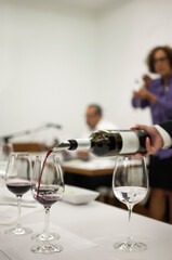 A man Pours A Fresh Glass Of Wine at a classroom