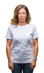 Fototapeta premium Middle age senior hispanic woman over isolated background with serious expression on face. Simple and natural looking at the camera.