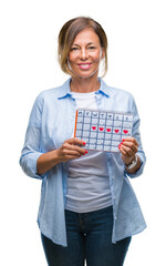 Middle age senior hispanic woman holding menstruation calendar over isolated background with a...