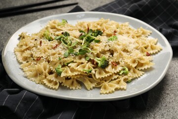 Vegetarian meal. Tasty pasta with fresh vegetables and cheese on grey table, closeup
