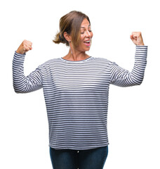 Middle age senior hispanic woman over isolated background showing arms muscles smiling proud. Fitness concept.