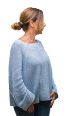 Middle age senior hispanic woman wearing winter sweater over isolated background looking to side, relax profile pose with natural face with confident smile.