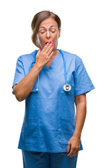 Middle age senior nurse doctor woman over isolated background bored yawning tired covering mouth with hand. Restless and sleepiness.