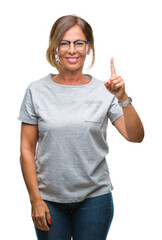 Middle age senior hispanic woman wearing glasses over isolated background showing and pointing up...