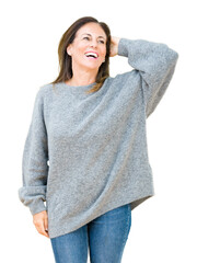 Beautiful middle age woman wearing winter sweater over isolated background Smiling confident...
