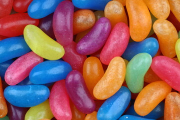 Colorful candy beans as texture and background for design. Close up view of jelly candy beans with selective focus.