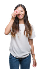 Young asian woman eating donut over isolated background with a happy face standing and smiling with...
