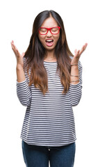 Young asian woman wearing glasses over isolated background celebrating mad and crazy for success...
