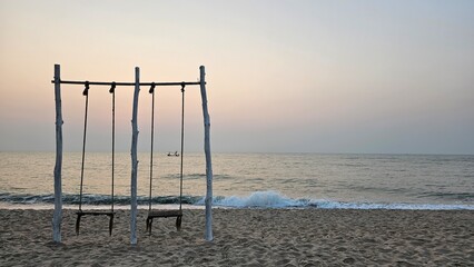 seaside swing, swing on the beach with sea wave background, romantic scene, 
