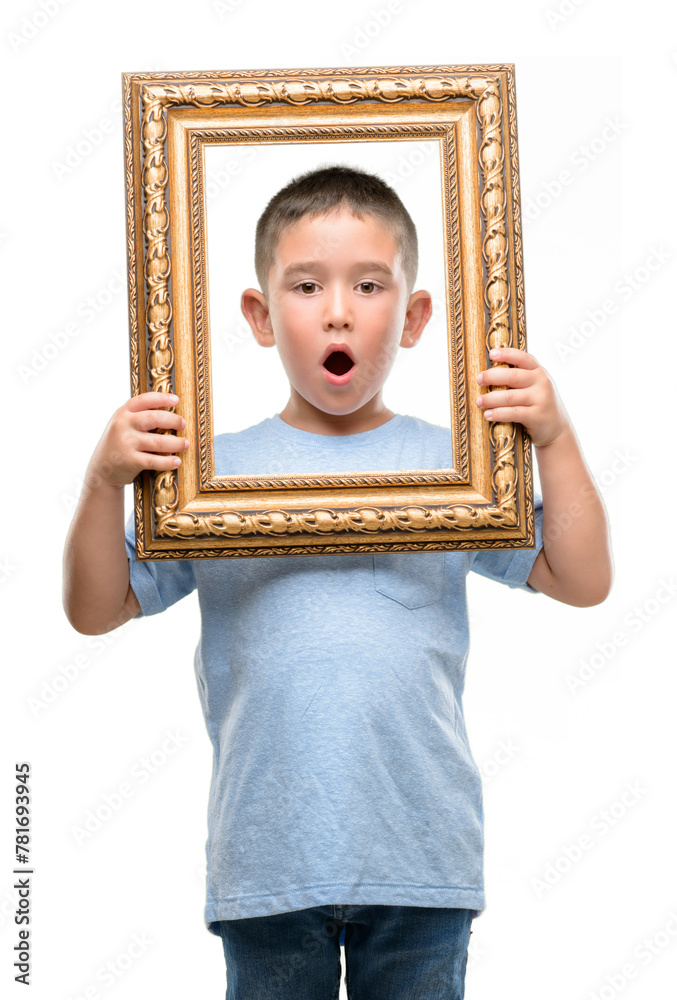 Sticker Dark haired little child holding frame very happy and excited, winner expression celebrating victory screaming with big smile and raised hands