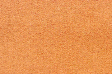 Close up orange fabric abstract background. Surface of felt fabric texture in autumn leaves color...