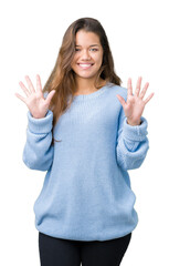 Young beautiful brunette woman wearing blue winter sweater over isolated background showing and pointing up with fingers number ten while smiling confident and happy.
