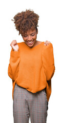 Beautiful young african american woman over isolated background celebrating mad and crazy for...