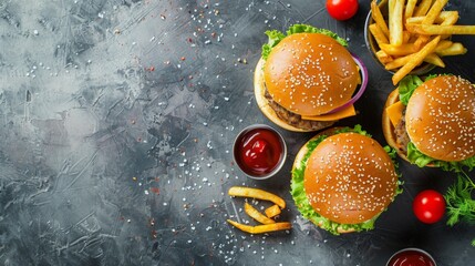 Three hamburgers and fries with ketchup on black surface