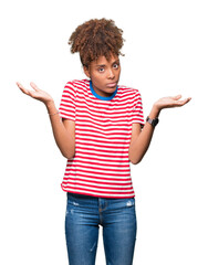 Beautiful young african american woman over isolated background clueless and confused expression...