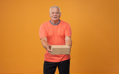 elderly man gives a box - 781707986