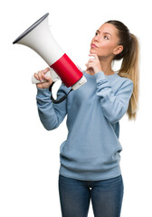 Beautiful young woman holding megaphone serious face thinking about question, very confused idea