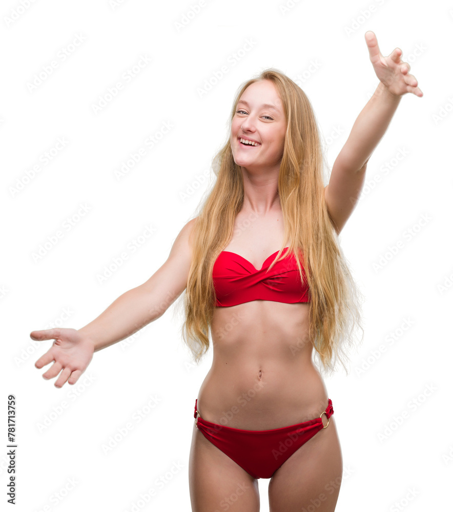 Poster Blonde teenager woman wearing red bikini looking at the camera smiling with open arms for hug. Cheerful expression embracing happiness.