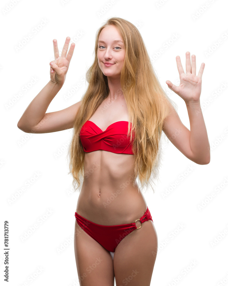 Sticker Blonde teenager woman wearing red bikini showing and pointing up with fingers number eight while smiling confident and happy.