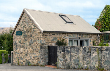 The Stable, a stone edifice from 1870, stands in Queenstown as a testament to historical architecture, with its rustic stone walls and classic design, encapsulating the essence of the era.