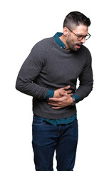 Fototapeta premium Young handsome man wearing glasses over isolated background with hand on stomach because indigestion, painful illness feeling unwell. Ache concept.