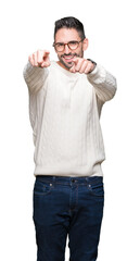 Fototapeta premium Young handsome man wearing glasses over isolated background Pointing to you and the camera with fingers, smiling positive and cheerful
