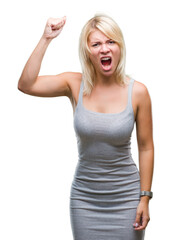 Fototapeta premium Young beautiful blonde woman over isolated background angry and mad raising fist frustrated and furious while shouting with anger. Rage and aggressive concept.