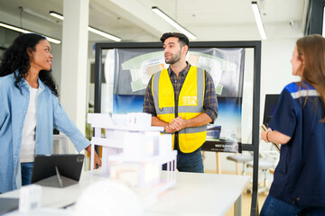 Architect and engineers wearing safety vests while analyzing solar power solutions over...