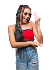 Young braided hair african american with birth mark wearing sunglasses over isolated background...