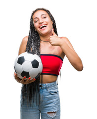 Young braided hair african american with birth mark holding soccer ball over isolated background...