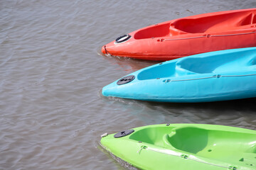 Blue red and green kayak on water outdoor activity background