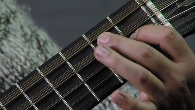A Man Playing A Chilean Stringed Instrument Called "Guitarron", Santiago de Chile, Chile. Close Up.