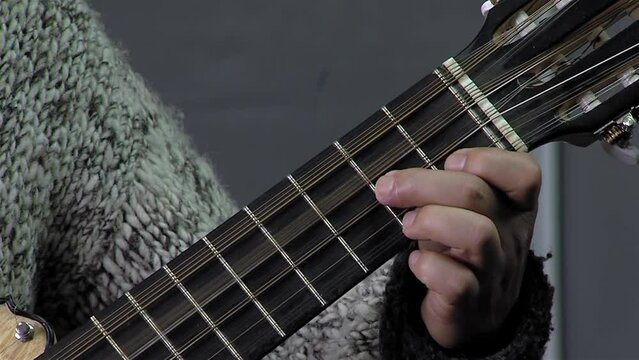 A Man Playing A Chilean Stringed Instrument Called "Guitarron", Santiago de Chile, Chile. Close Up.