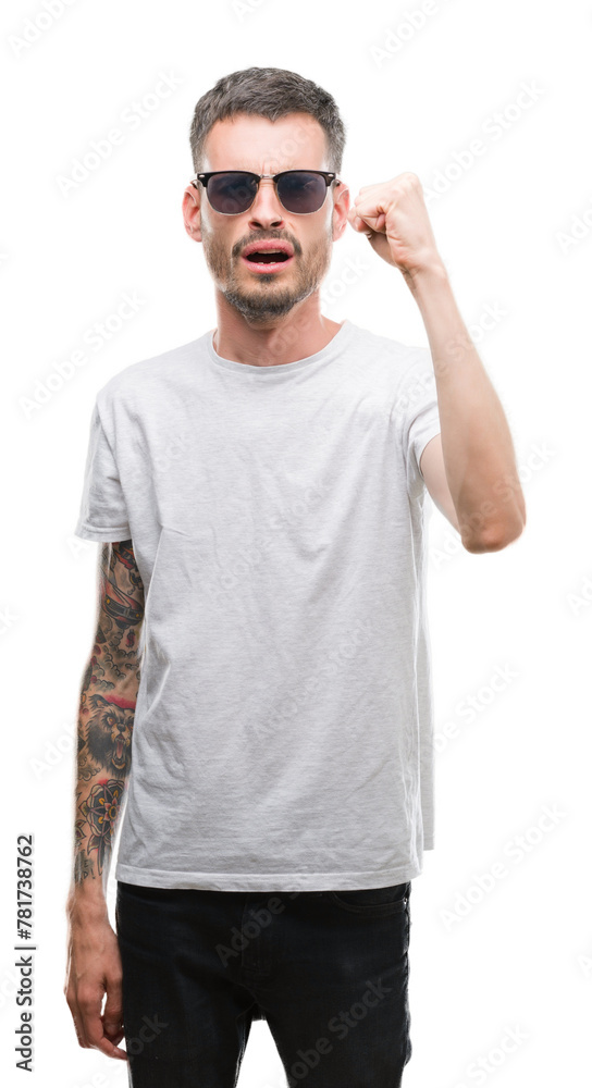 Wall mural young tattooed adult man wearing sunglasses annoyed and frustrated shouting with anger, crazy and ye