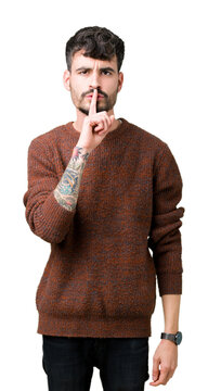 Young handsome man wearing winter sweater over isolated background asking to be quiet with finger on lips. Silence and secret concept.
