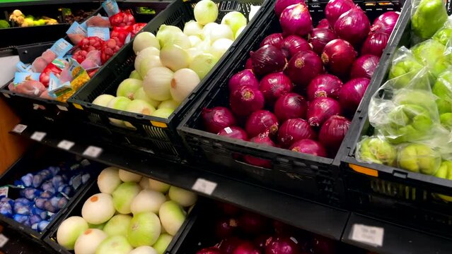 White And Purple Onions, Potatoes, Piled And Displayed In The Supermarket Counter Slow Motion Shot