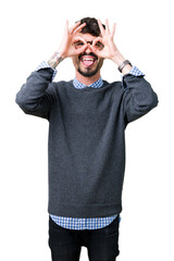 Young handsome smart man wearing glasses over isolated background doing ok gesture like binoculars sticking tongue out, eyes looking through fingers. Crazy expression.