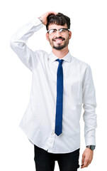 Young handsome business man wearing glasses over isolated background Smiling confident touching hair with hand up gesture, posing attractive