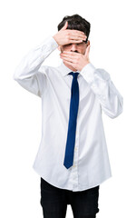 Young handsome business man wearing glasses over isolated background Covering eyes and mouth with hands, surprised and shocked. Hiding emotion