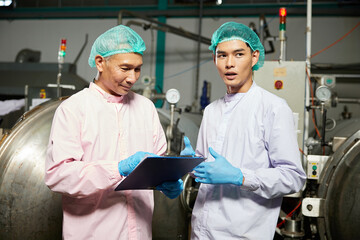 male workers meeting and talking about work or project in the beverage factory