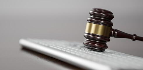 Gavel at the computer keyboard: Legal and law concept. Wooden hammer of justice and order - 781745152