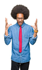 Young african american business man with afro hair wearing glasses and red tie celebrating mad and...
