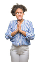 Young afro american woman over isolated background begging and praying with hands together with...