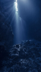 Underwater photo of magic sunlight and holy grail inside a cave